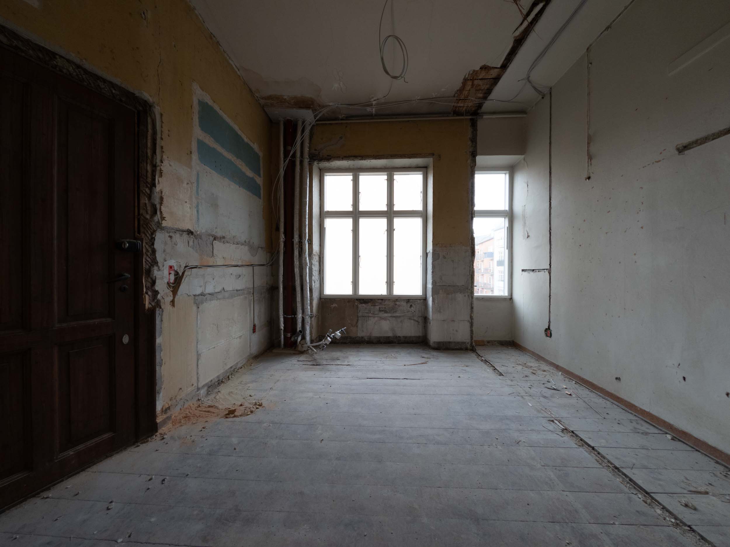 Værelse langs rummet mod vinduerne før totalrenovering